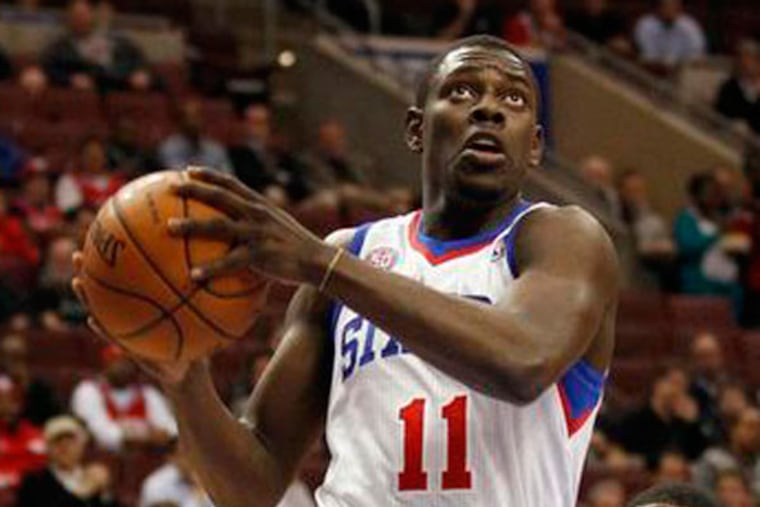 Sixers' Jrue Holiday drives to the basket against Washington Wizards'
John Wall (right) and Martell Webster in the first quarter on Wednesday, January 30, 2013. (Yong Kim/Staff Photographer)