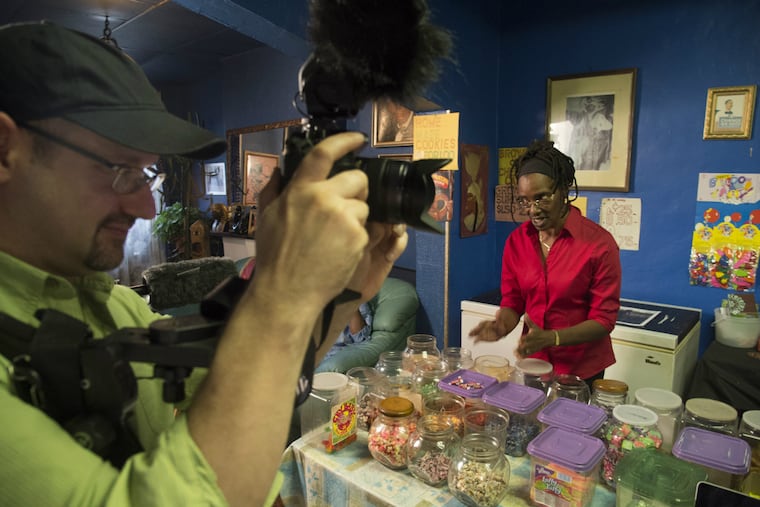 Nandi "Miss Nandi" Muhammad, 63, talks about her life in her North
Philadelphia home where she runs a small penny-candy store for the
neighborhood kids, as artist-in-residence from
the Village of Arts and Humanities, Mike Keutemeyer, 48, takes video.