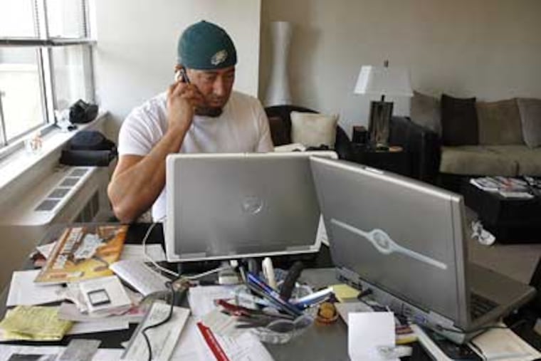 Craig “Quimby” Chenosky specializes in travel packages for Eagles away games. He was putting together travel plans for the Birds’ playoff game in Minnesota against the Vikings on Sunday. (Bonnie Weller / Staff Photographer)