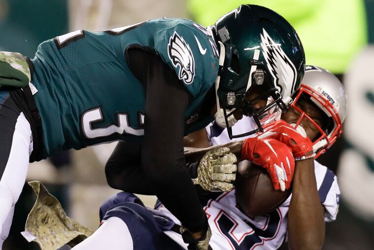 Eagles cornerback Rasul Douglas lands a hit on New England Patriots wide receiver Phillip Dorsett during the third quarter.