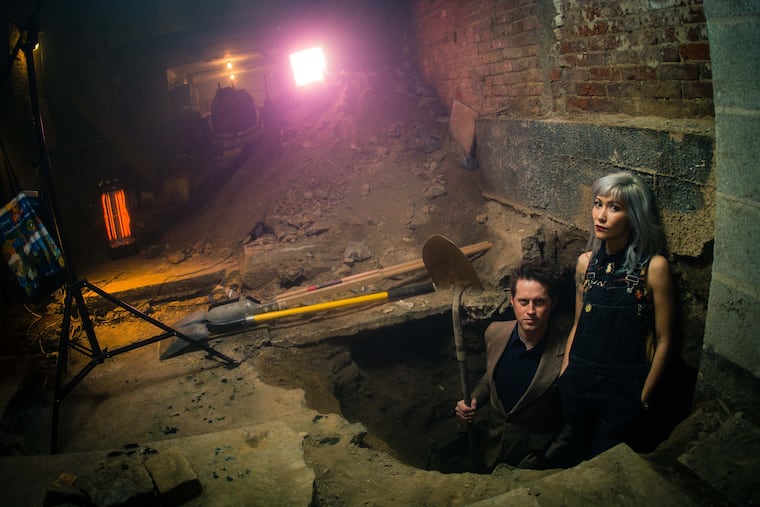 Amateur diggers Melissa and Matt Dunphy stand in one of the privies they found below their house and theater in Old City.