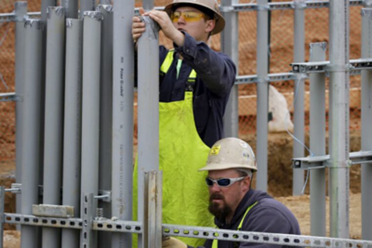 The crew installing the solar array at Longwood Gardens included electricians Cody Combs (left) and Chris Mock. (Michael S. Wirtz / Staff Photographer)
