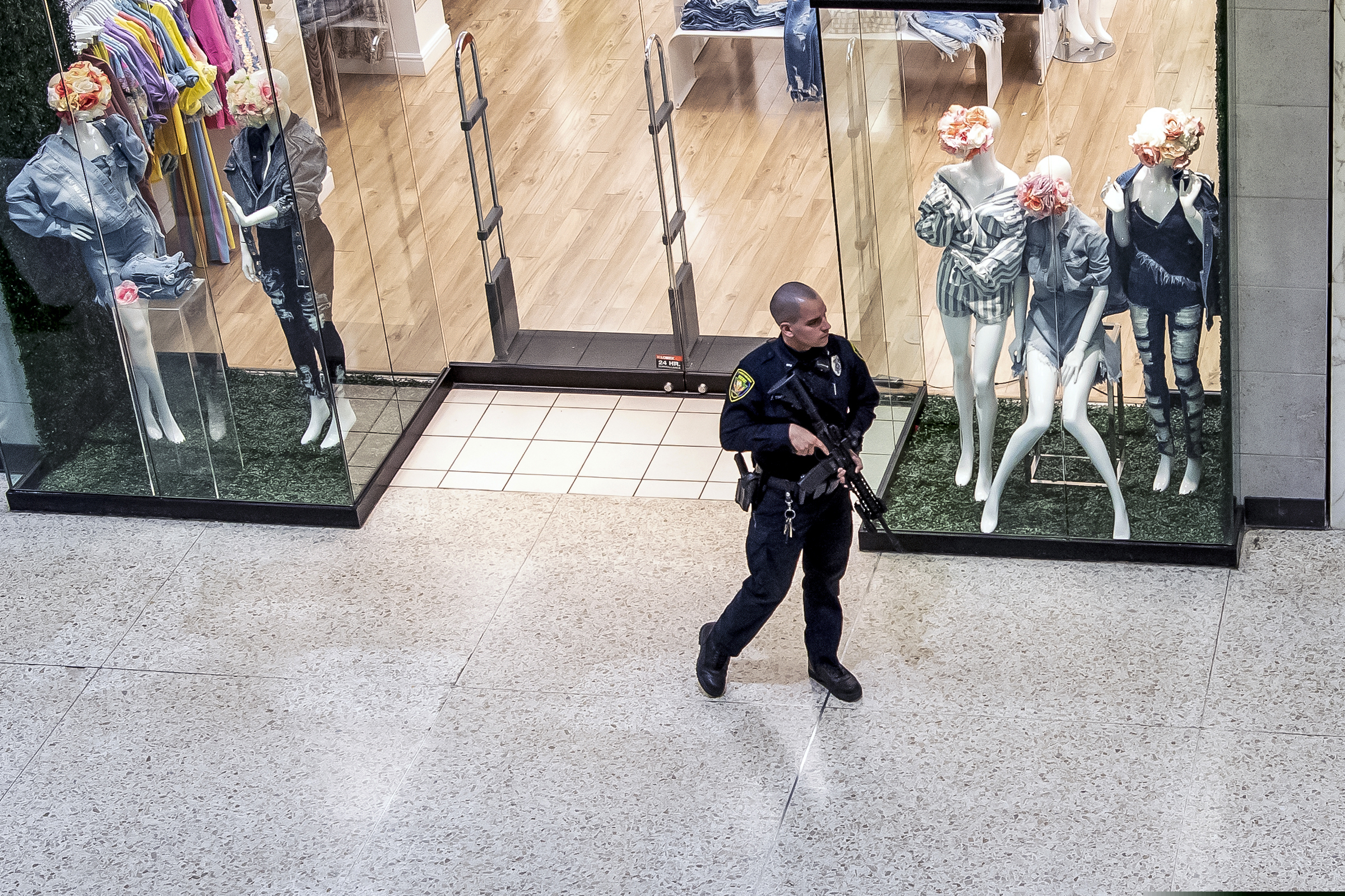 Responding to a call of shots fired, a Monroeville police officer patrols the Monroeville Mall, Friday, April 12, 2019, in Monroeville, Pa. (Alexandra Wimley / Pittsburgh Post-Gazette via AP)