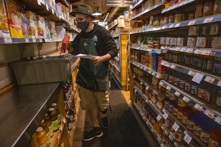 Alec Cuthbert, home delivery coordinator at Weavers Way Co-op, prepares an order for home delivery in August.