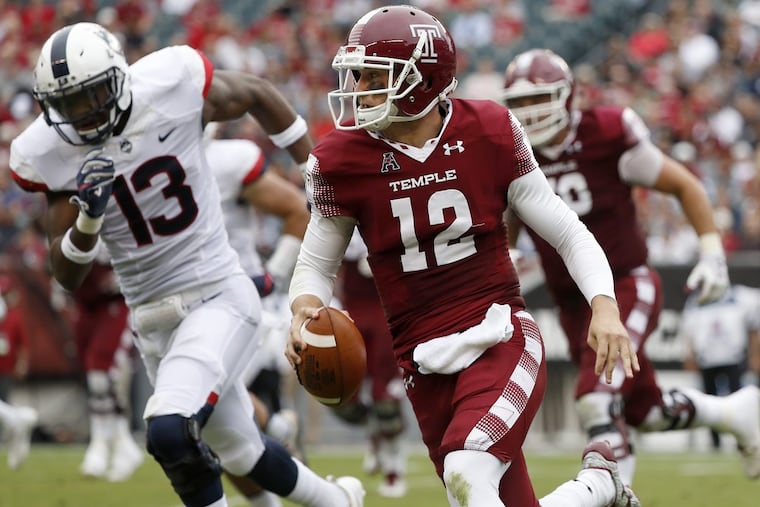 Temple’s quarterback Logan Marchi, right, keeps the ball as UConn’s Vontae Diggs, left, gives chase in the 2nd quarter as the Temple Owls play the UCONN Huskies in Philadelphia, PA on October 14, 2017. DAVID MAIALETTI / Staff Photographer