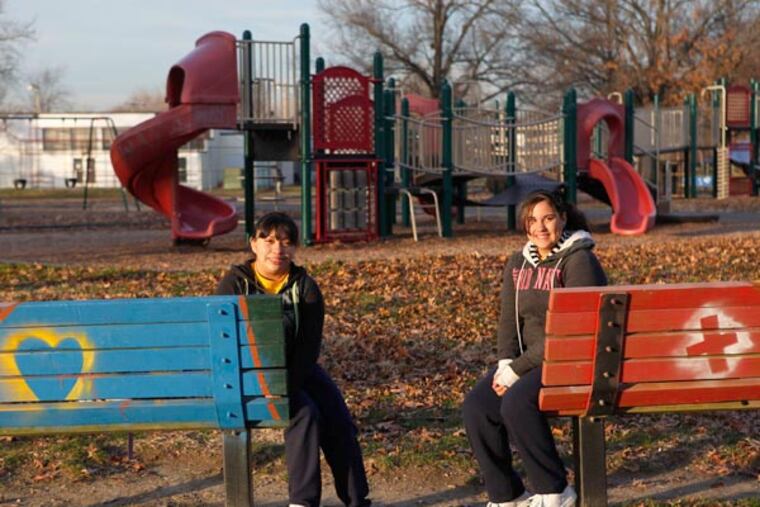 Student leaders Soledad Velazquez (left) and Nelmaris Laureano, both 13 and eighth graders at Saint Anthony of Padua School, are among youths who helped paint benches and clean up garbage at Camden's Von Nieda Park. (Michael S. Wirtz / Staff Photographer)