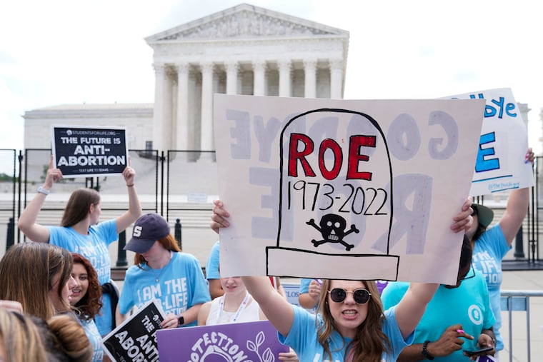 Demonstrators gather outside the U.S. Supreme Court Building in Washington last June, hours after the justices issued the "Dobbs" decision eliminating federal protections for abortion rights.