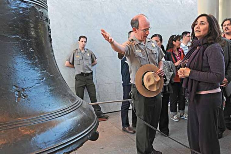 Mariela Castro, niece of Fidel Castro and daughter of Raul Castro, visits the Liberty Bell on 5/3/13. At left, telling her about the Bell, is park ranger and interpreter Karl Schaffenburg. ( APRIL SAUL / Staff )