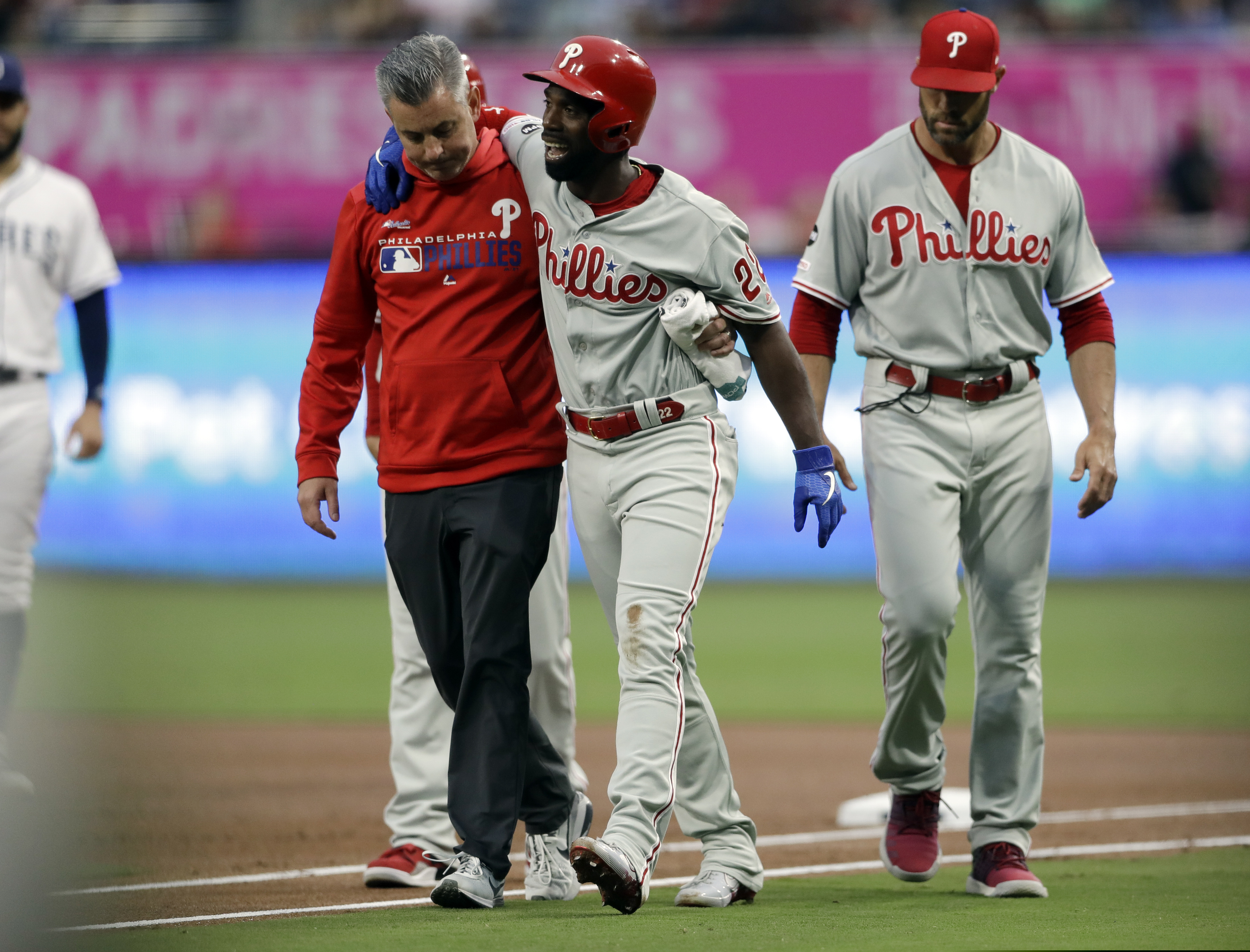 Outfielder Andrew McCutchen is helped off the field after injuring his knee in the first inning of the Phillies' 8-2 loss to the Padres on Monday.