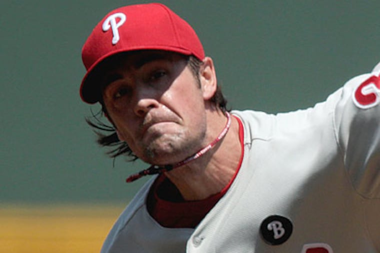 Cole Hamels allowed just five batters to reach base Sunday, and retired the first 10 Braves he faced. (David Goldman/AP)