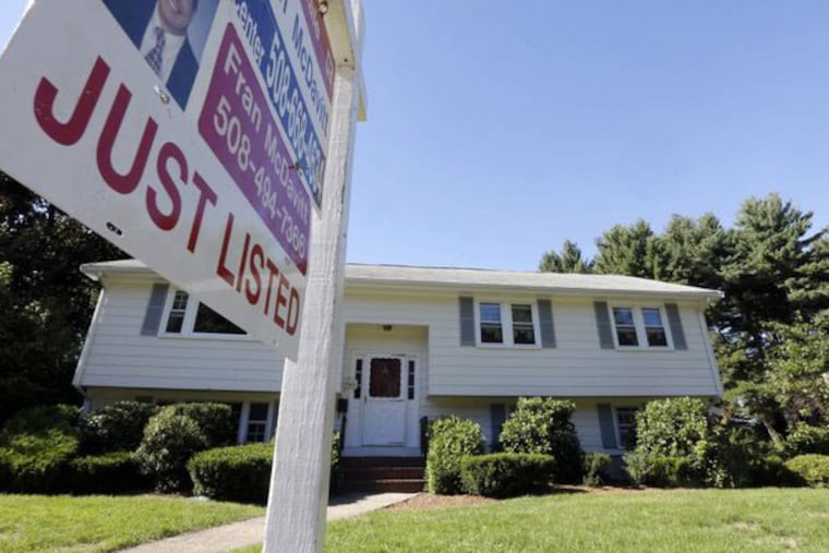 FILE - In this Wednesday, Sept. 18, 2013, file photo, a "For Sale" sign hangs in front of a house in Walpole, Mass. Americans bought fewer existing homes in September than the previous month, held back by higher mortgage rates and rising prices, the National Association of Realtors said Monday, Oct. 21, 2013. (AP Photo/Steven Senne)