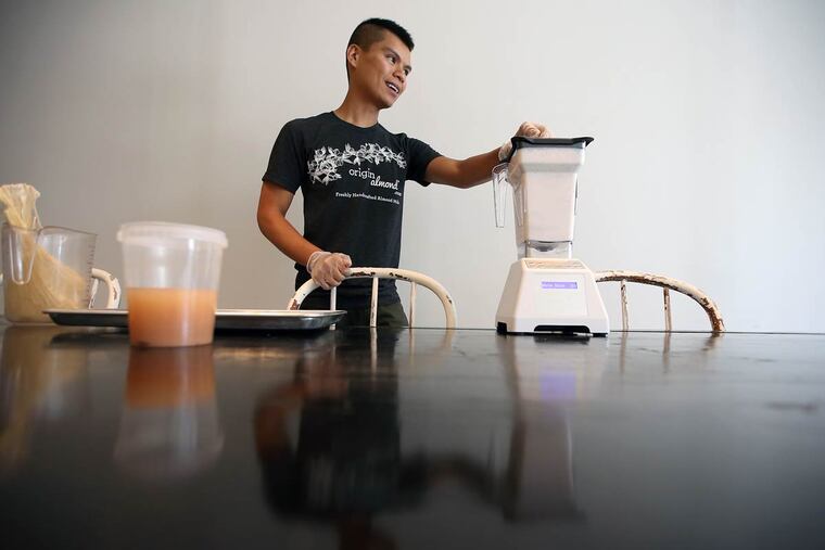 Jake Deleon, owner of Origin Almond, makes an almond milk drink at Heart Beet Kitchen in Westmont, N.J.