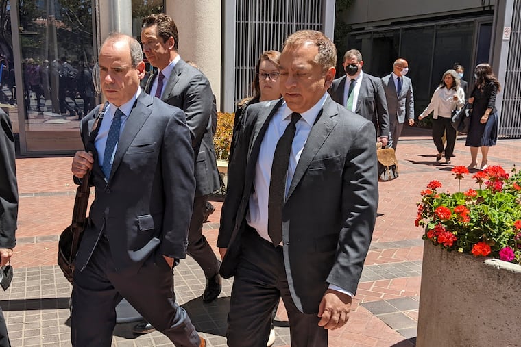 Ramesh "Sunny" Balwani, right, the former lover and business partner of Theranos CEO Elizabeth Holmes, leaves a San Jose, Calif., federal courthouse with his lawyers on Thursday.