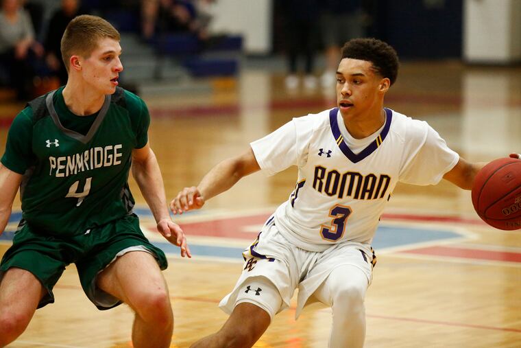 Roman Catholic guard Lynn Greer III (right) keeps the ball away from Pennridge guard Sean Yoder.