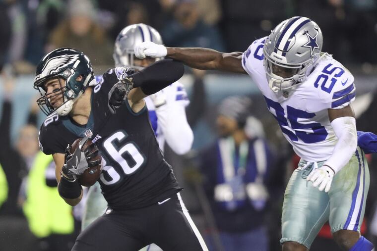 Zach Ertz runs past the Cowboys' Xavier Woods to score a third-quarter touchdown.