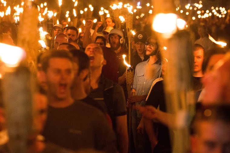 Neo-Nazis, alt-Right, and white supremacists march the night before the "Unite the Right" rally in Charlottesville, Va., in 2017. The rising threat of violent white supremacist extremism prompted the state of New Jersey to call the threat "high," a rating above jihadist groups Al Qaeda and ISIS.
