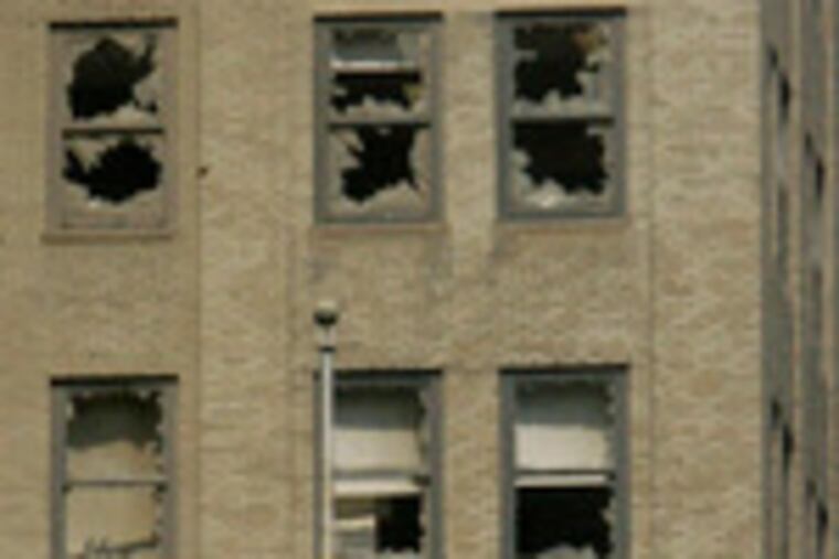 Blown-out windows on a building at Lexington Avenue and 41st Streetin New York show the power of the steam-pipe explosion that sent a geyser of steam and debris through a midtown Manhattan street.