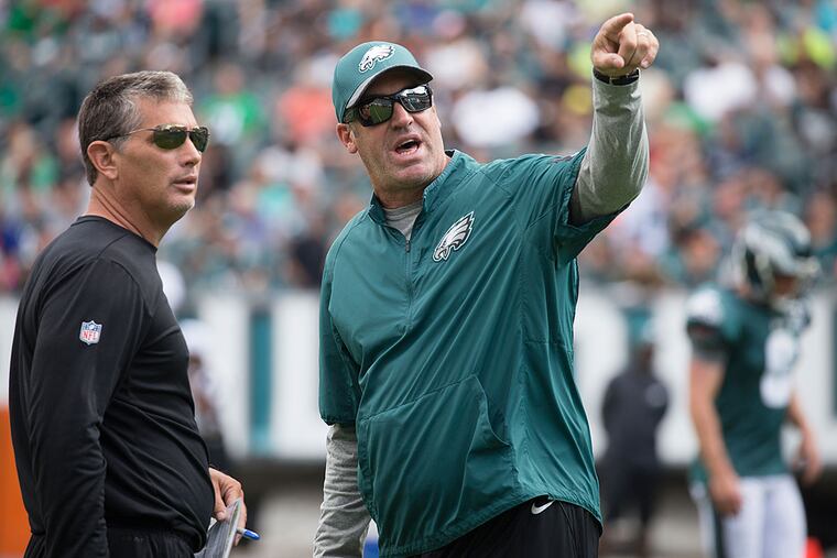 Eagles head coach Doug Pederson, right, talks to defensive coordinator Jim Schwartz during practice. Thursday's preseason opener will be their first game working together with the Eagles.