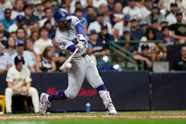 Mookie Betts hits an RBI single for the Dodgers during the seventh inning Monday against the Brewers.
