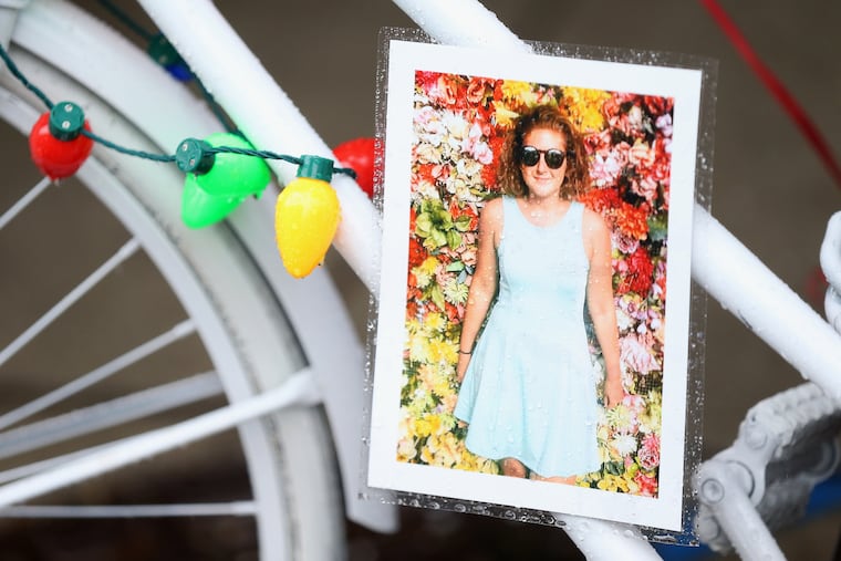 A photo of Emily Fredricks, a cyclist recently killed by a garbage truck, is pictured on a ghost bike at the crash site, 11th and Spruce streets, on Saturday, Dec. 23, 2017. The ghost bike was provided by the Bicycle Coalition of Greater Philadelphia. TIM TAI / Staff Photographer