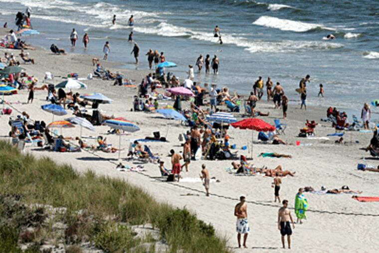 The daytime high tide puts Shore beach space at a premium, especially at popular spots such at 40th Street in Sea Isle City. (Akira Suwa / Inquirer)