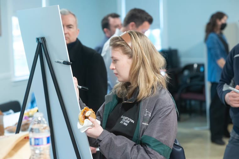 Belle Brodbeck of Langhorne Manor writes a suggestion on a board as members of the public attended a SEPTA open house at Penndel Borough Hall on plans for a housing and retail development land next to Langhorne Station.