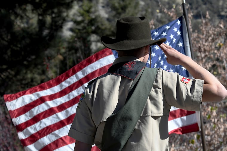 Boy Scouts lead the Pledge of Allegiance to begin a Veterans Day ceremony in Wrightwood, Calif., in2018. The Boy Scouts are now facing bankruptcy.