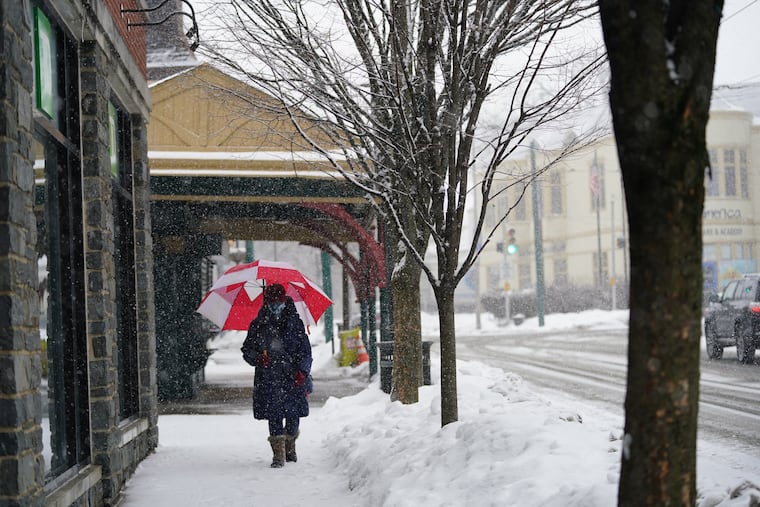 Elizabeth Humphreys walks in the snow in Chestnut Hill on Monday.