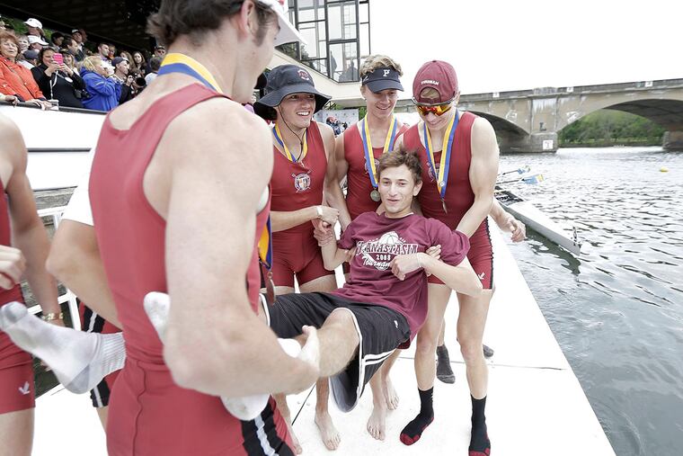 St. Joseph's Prep coxswain Ryan Shearn is about to be thrown in the river after they won the lightweight eight final during the Stotesbury Regatta on the Schyulkill River in Phila. on May 21, 2016. ELIZABETH ROBERTSON / Staff Photographer