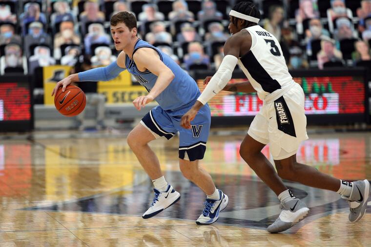 Providence's David Duke (3) defends Villanova's Chris Arcidiacono (4) during the second half of an NCAA college basketball game in Providence, R.I., on March 6.