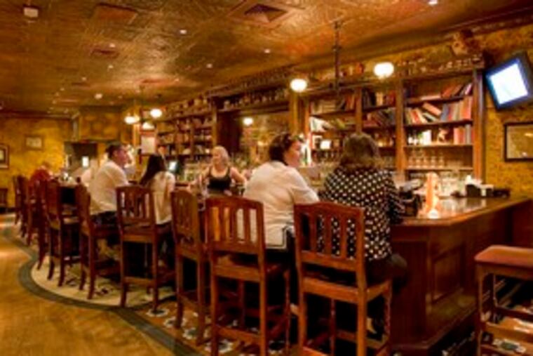 At the near end of the bar, Judy Dietrich (right) and Pat Trombino are enjoying a quiet drink at the Trinity Pub. Trinity specializes in drinks and comfort food.