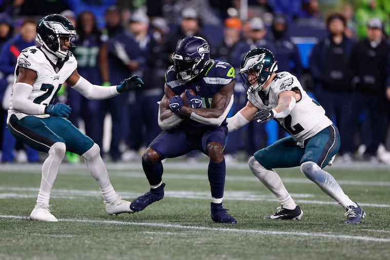 Eagles safety Reed Blankenship (right) and cornerback James Bradberry go after Seattle Seahawks wide receiver DK Metcalf at Lumen Field in Seattle on Monday, December 18, 2023.