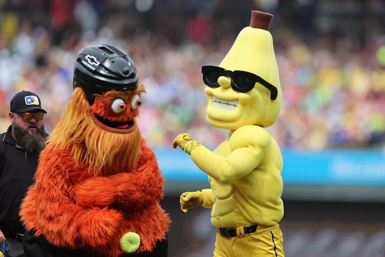 Flyers mascot Gritty and Savannah Bananas mascot Split pretend to fight before the Bananas play the Texas Tailgaters in Philadelphia on July 27.