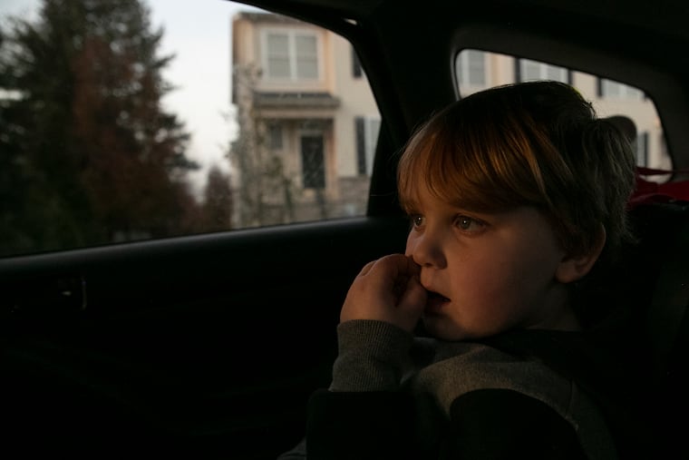 Homes pass by as J.J. Borgesi, 12, sits in the backseat of the car as he and his mom take their daily afternoon drive to look for housing around the Bridgeport, Pa. area on Wednesday, Dec. 1, 2021. Amy Hylenski and her son were displaced after the flooding from Ida and is currently living with her mother until they can find an affordable home.