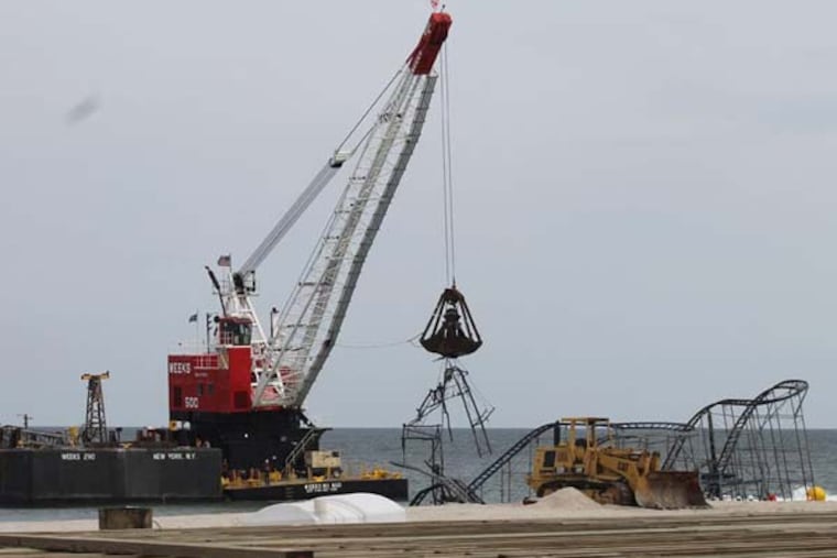 A floating barge began to demolish the Jet Star roller coaster in Seaside Heights which was destroyed by Hurricane Sandy. (Amy Rosenberg / Staff)