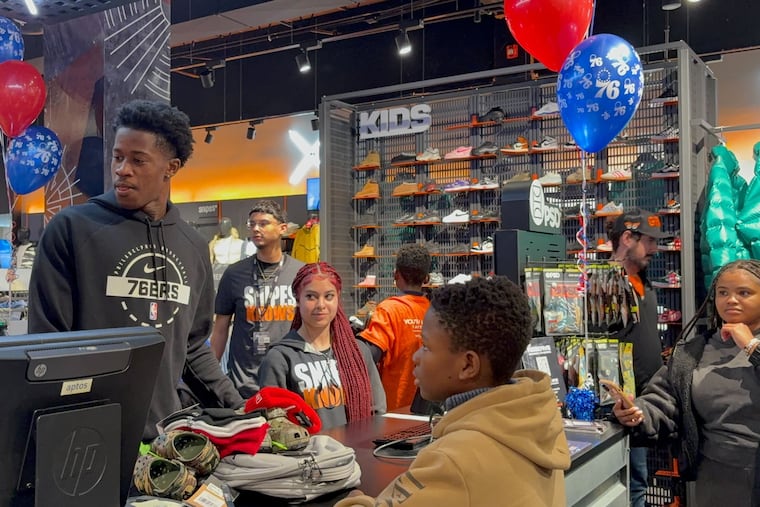 VJ Edgecombe packing away orders from local youth after their $500 shopping spree at SNIPES.