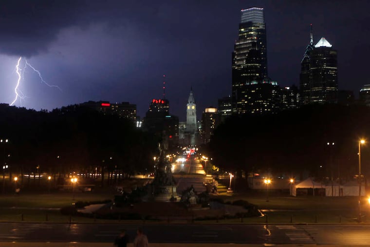 Lightning flashes northeast of Center City, as seen from the steps of the Art Museum overlooking Eakins Oval and the Ben Franklin Parkway in this file photo.