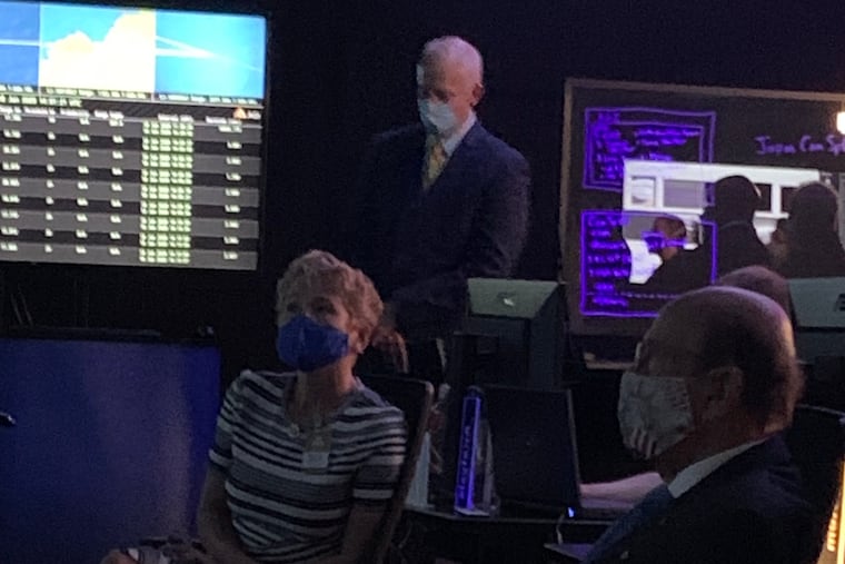 At Analytical Graphics Inc. in Exton, Pa., U.S. Rep. Chrissy Houlahan, D-Pa. 6th; Joe Sheehan, President of Analytical Graphics Inc., and U.S. Secretary of Commerce Wilbur Ross, review how the company's systems are used to track satellites and "space junk" for