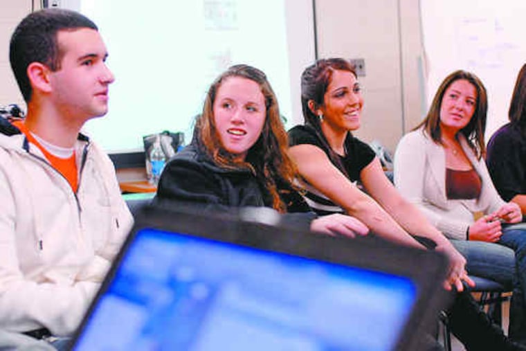 Springfield High students (from left) Rob Toomey, Mary Reilly, Elizabeth Koppe and Staci Rice discuss their coverage of the inauguration. The Delaware County school is participating in a statewide project.