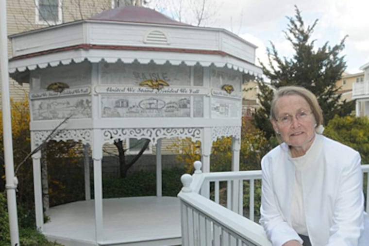 Louise Clemente on the deck of her Sea Isle City home, feet from the gazebo whose height has become a bone of contention between her and local officials. CURT HUDSON / FOR THE DAILY NEWS