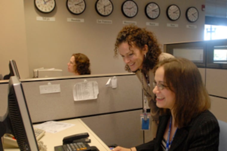 At Lockheed Martin's Lifetime Command Support Center for aircraft tires in Moorestown, logistics analysts Peggy Thornton (left) and Sandy Ebenhoech work.