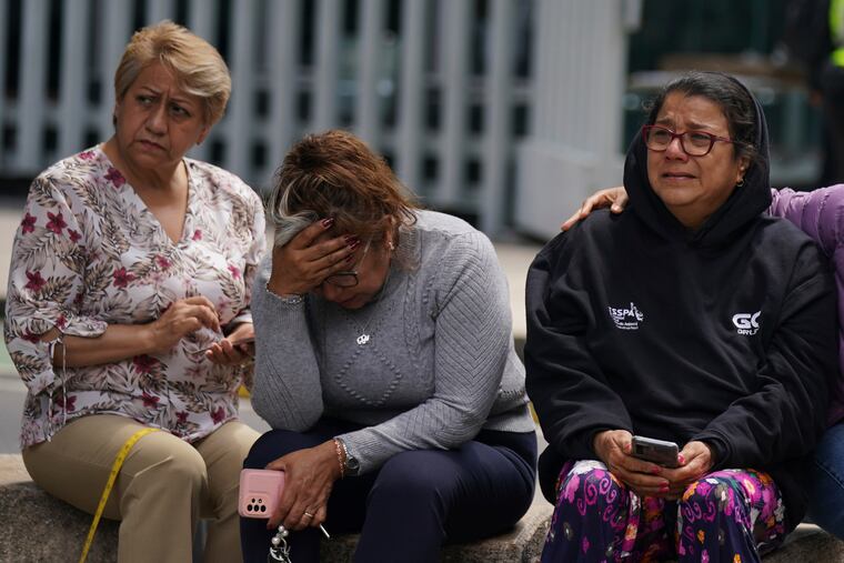 People gather outside after a magnitude 7.6 earthquake was felt in Mexico City on Monday.