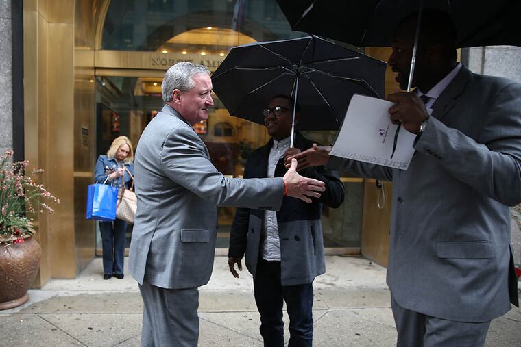 Jim Kenney shakes hands with two people as he nears his campaign headquarters. He won a shockingly easy victory on Tuesday to represent his party in the fall. (DAVID MAIALETTI/Staff Photographer)
