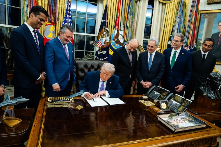 President Donald Trump signs an executive order on artificial intelligence at the White House on Dec. 11.