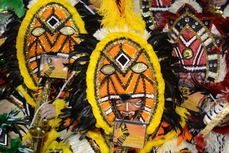 Ed Farrell (center), playing his alto sax during the Woodland String Band's 2012 championship performance, returned from military service in the Middle East this year in time to strut in the New Year's Day parade. (Photo courtesy of the Woodland String Band)