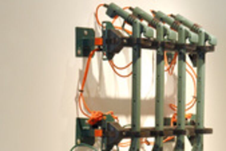 The TODT group's "Phalanx": Weed whacker-type machines affixed to the wall. The noise, when the contraption is plugged in, can empty the gallery.