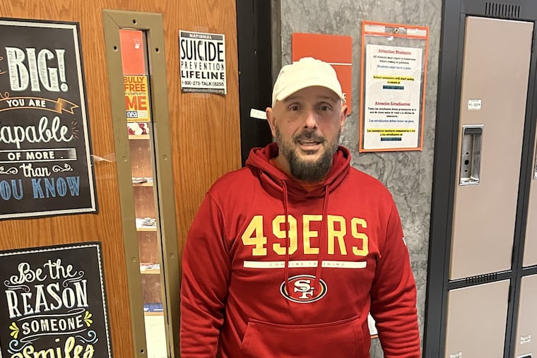 Camden's Eastside High teacher Teddy Munz is an Eagles fan. He wore a 49ers sweatshirt on Wednesday after losing a bet with a student.