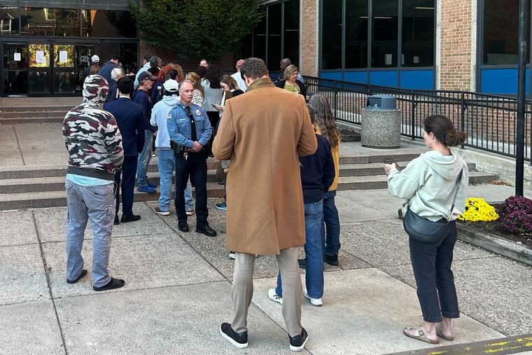 People wait in line to cast on-demand mail ballots at a Bucks County government building in Doylestown.