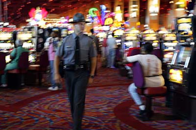 State Trooper Steve Stigliano walks the gaming floor at Harrah's Chester Casino & Racetrack. (DAVID MAIALETTI / Daily News)