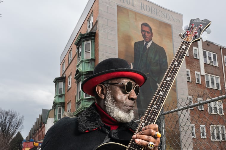 Jamaaladeen Tacuma, a jazz-funk bass player and longtime Philadelphia musician, is shown here on Chestnut Street between 45th and 46th Streets, in front of the Paul Robeson mural, a Mural Arts Philadelphia painting, which was painted by Mural Arts Philadelphia artist Ernel Martinez, in Philadelphia, Tuesday, January 25, 2022.
